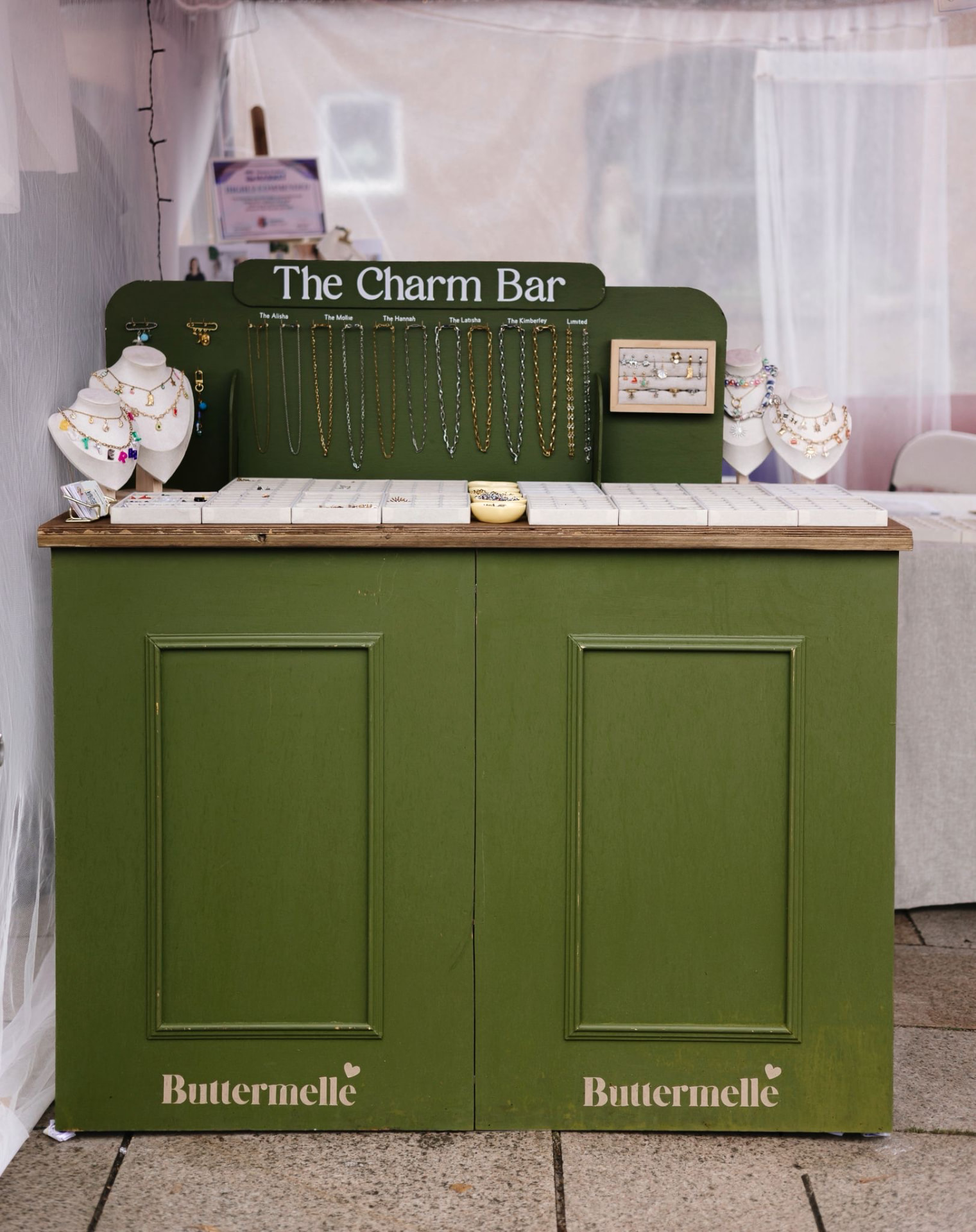 The Buttermelle Charm Bar set up with trays of charms